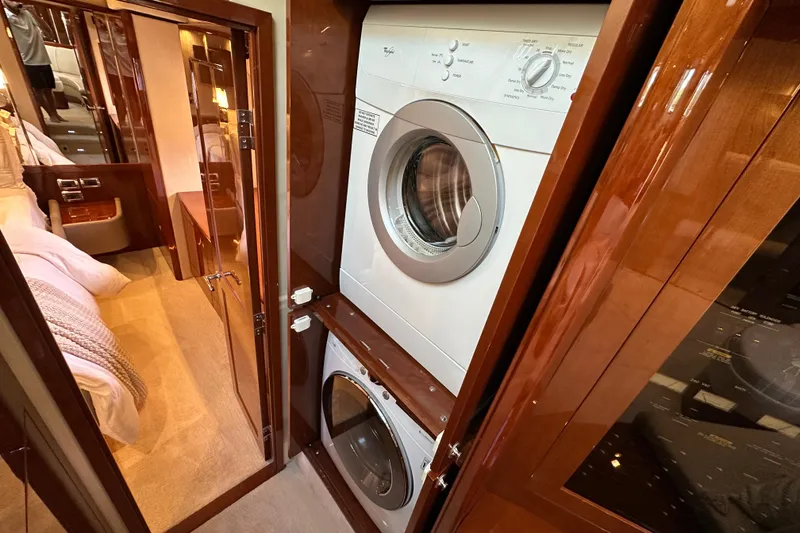 Slide: The Image of Laundry area inside 2009 Sea Ray 60 Sundancer yacht with stacked washer and dryer. - 25