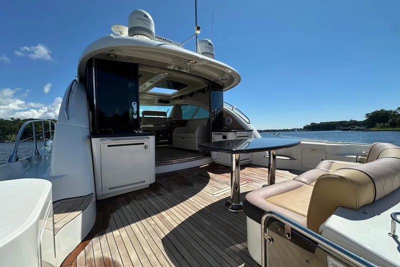 Slide: The Image of 2009 Sea Ray 60 Sundancer yacht with open deck, luxurious seating, and scenic water view. - 3