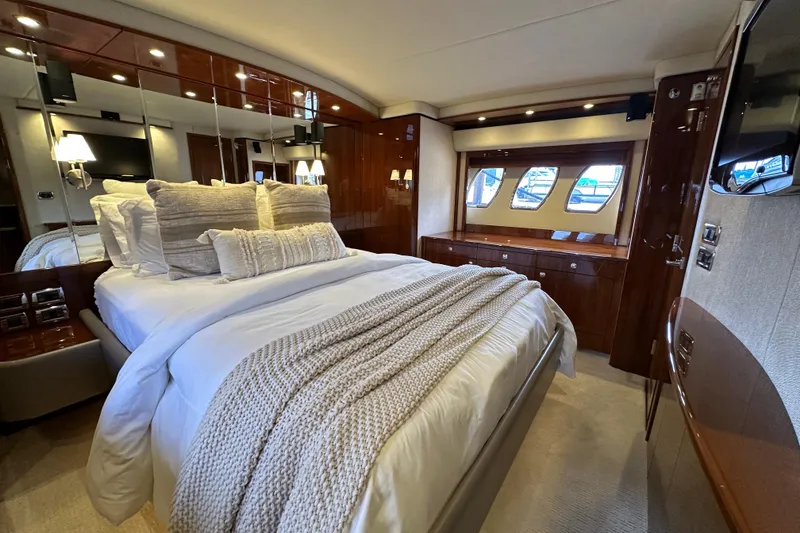Slide: The Image of Luxurious bedroom interior of 2009 Sea Ray 60 Sundancer yacht with elegant bedding and wood finishes. - 30