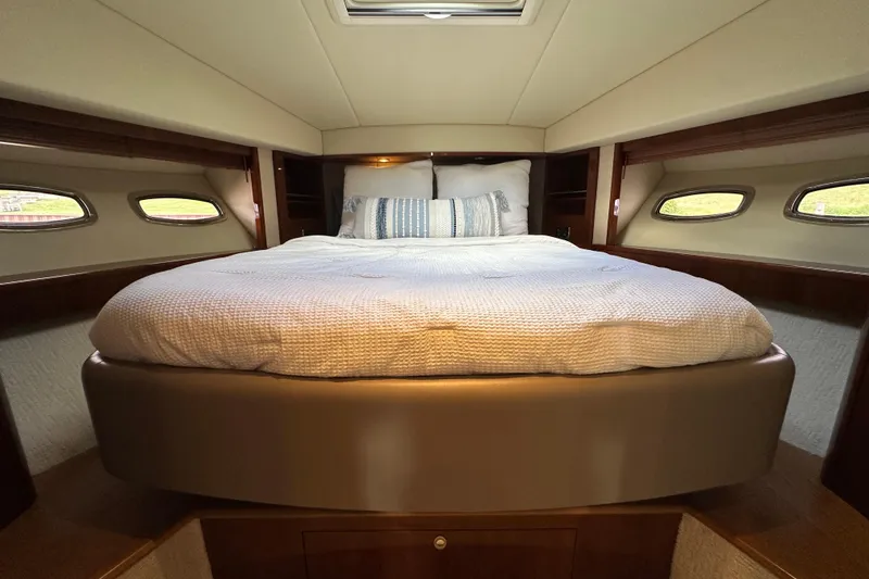 Slide: The Image of Luxurious bedroom interior of 2009 Sea Ray 60 Sundancer yacht with cozy bedding. - 31