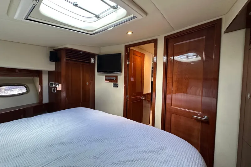 Slide: The Image of Luxurious 2009 Sea Ray 60 Sundancer cabin with wood finishes and skylight. - 32