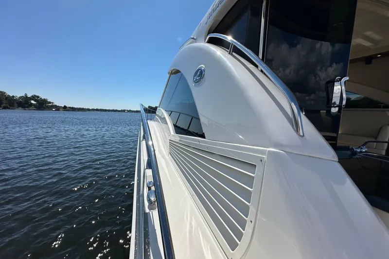 Slide: The Image of 2009 Sea Ray 60 Sundancer yacht on calm water under clear blue sky. - 44