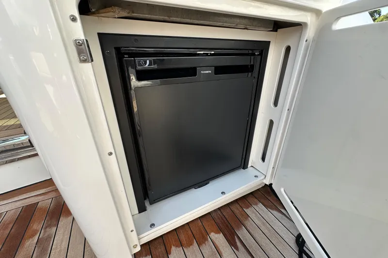 Slide: The Image of Built-in refrigerator on 2009 Sea Ray 60 Sundancer yacht, featuring sleek design and wooden flooring. - 7