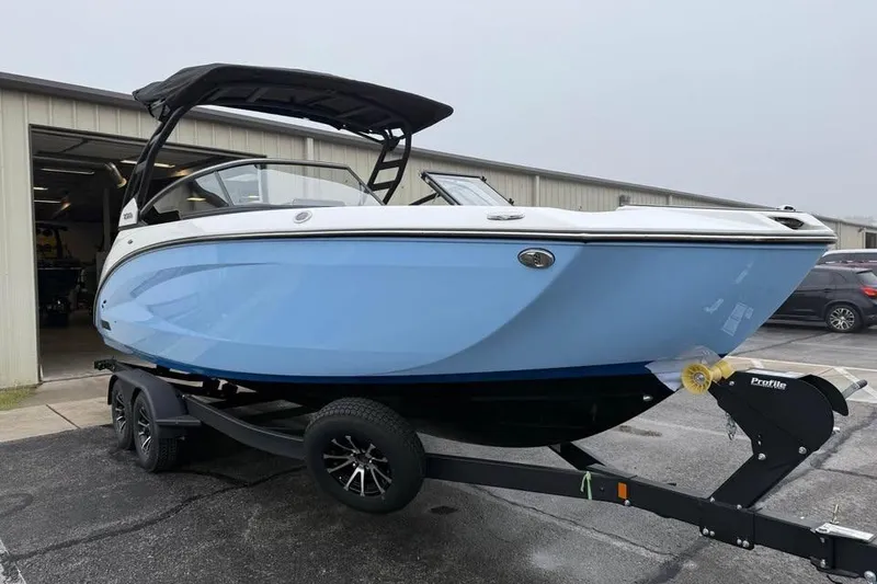 Slide: The Image of 2026 Yamaha Boats 252SD in light blue on trailer outside storage facility. - 1