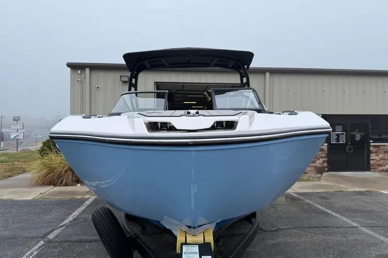 Slide: The Image of 2026 Yamaha Boats 252SD in front of a building, showcasing sleek design and modern features. - 2