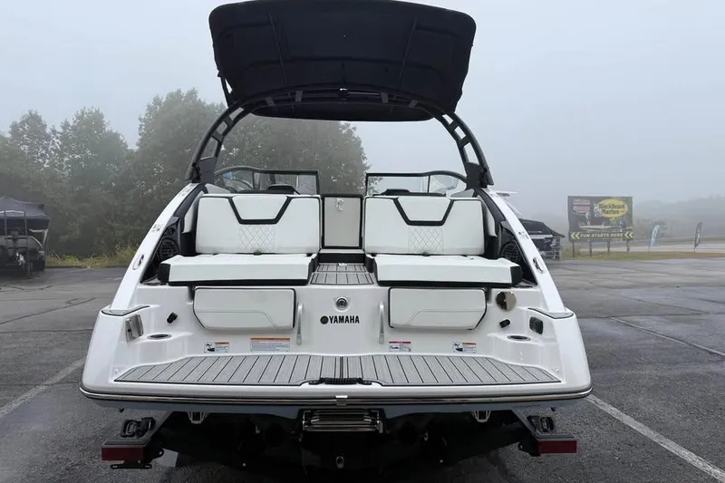 Slide: The Image of 2026 Yamaha Boats 252SD, rear view, showcasing seating and swim platform in a foggy setting. - 5