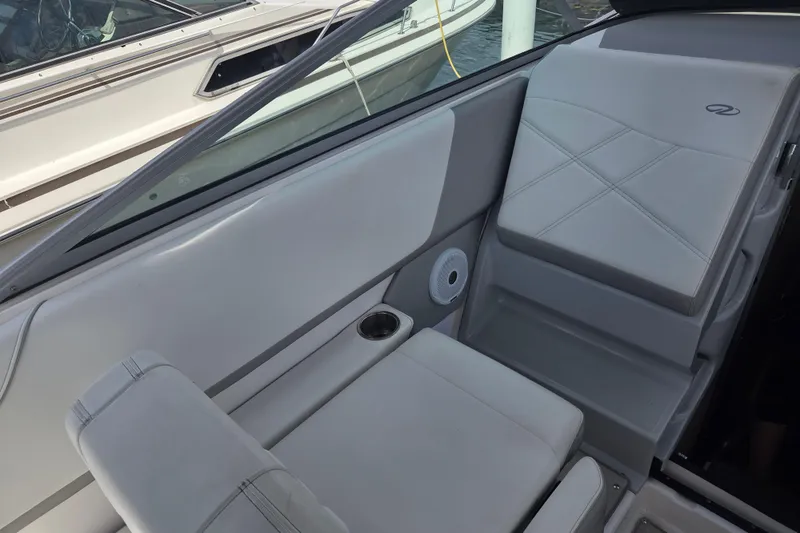 Slide: The Image of 2021 Regal 26 Express boat interior with gray seating and cup holder. - 11