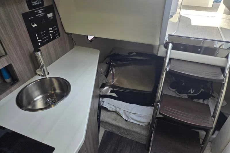 Slide: The Image of 2021 Regal 26 Express cabin interior with sink, stairs, and storage area. - 18