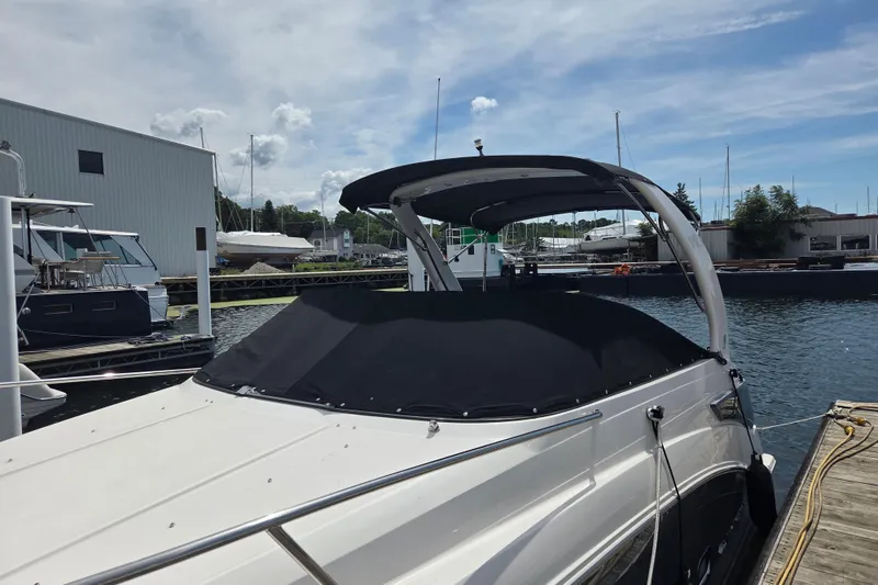 Slide: The Image of 2021 Regal 26 Express boat docked at marina under clear sky. - 2