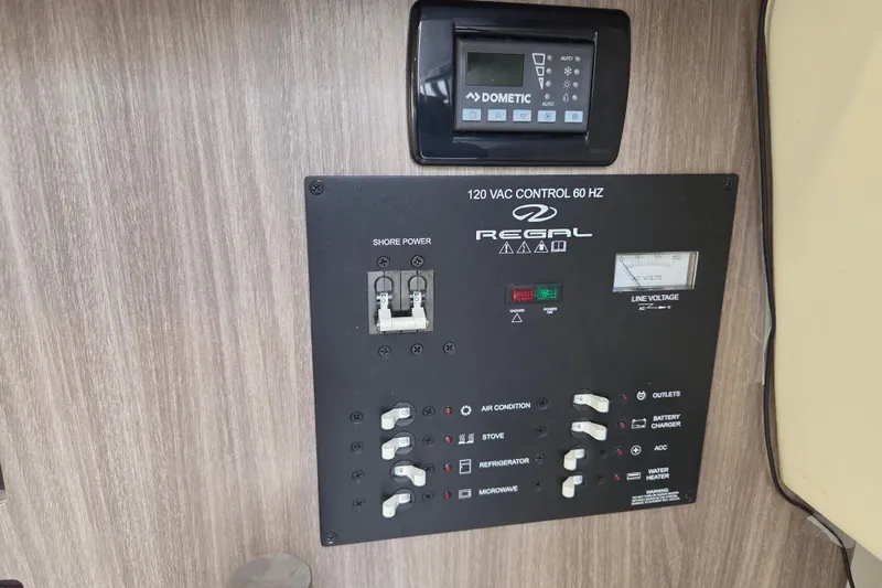 Slide: The Image of Control panel of a 2021 Regal 26 Express boat with various switches and a Dometic display. - 25