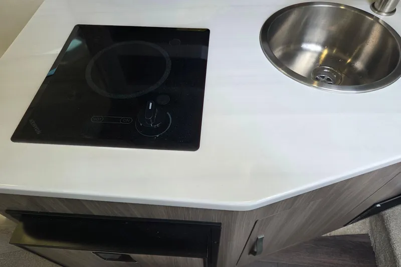 Slide: The Image of Modern kitchenette in 2021 Regal 26 Express boat with stove and sink. - 26