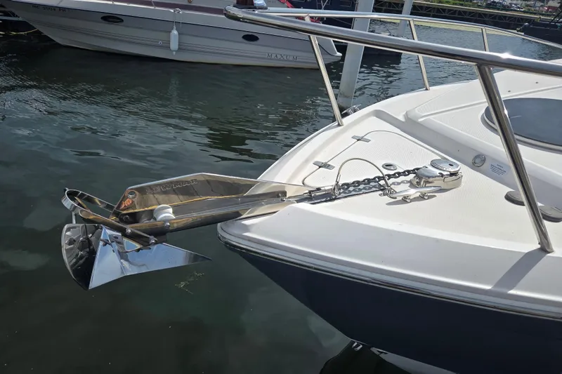 Slide: The Image of 2021 Regal 26 Express boat with anchor and chain on deck, docked in marina. - 28