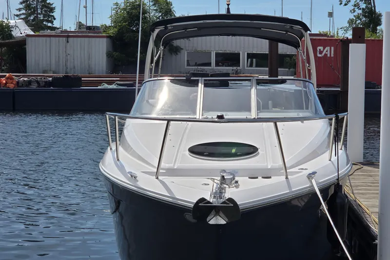 Slide: The Image of 2021 Regal 26 Express boat docked at marina, front view. - 29