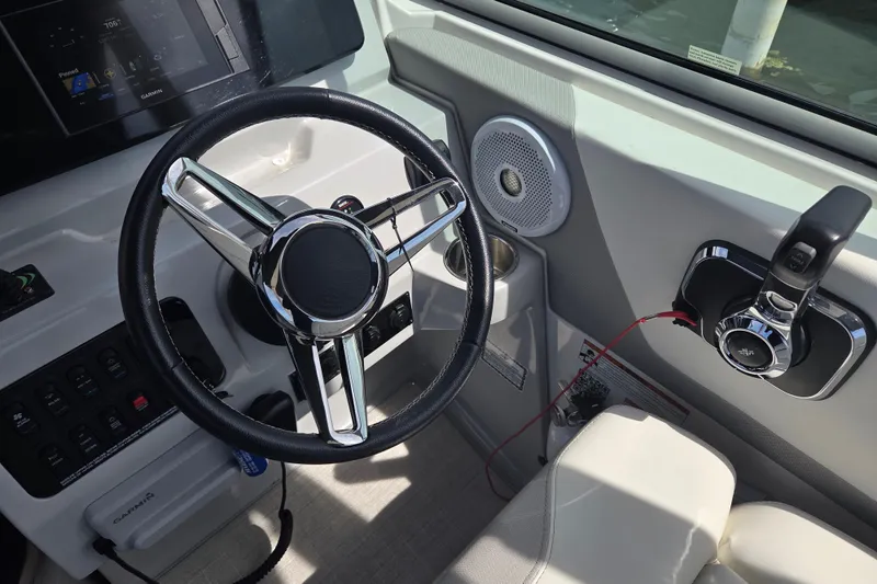 Slide: The Image of 2021 Regal 26 Express boat dashboard with steering wheel and control panel. - 3