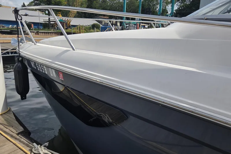 Slide: The Image of 2021 Regal 26 Express boat docked at a marina, side view. - 30