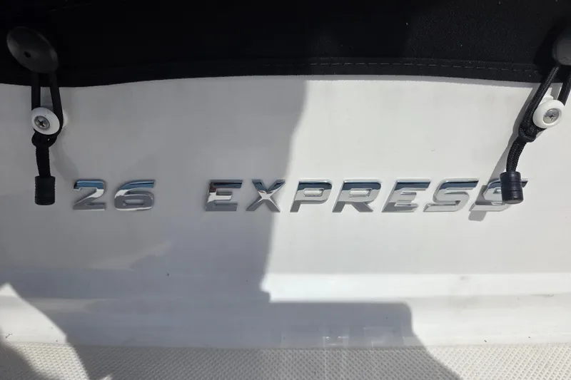 Slide: The Image of 2021 Regal 26 Express boat nameplate with chrome lettering and black fasteners. - 35