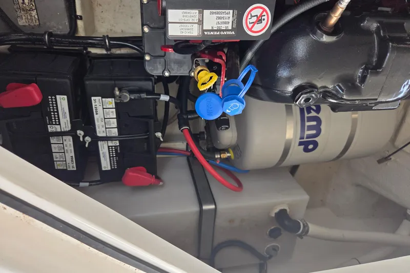 Slide: The Image of Engine compartment of a 2021 Regal 26 Express boat, showing batteries and wiring. - 36