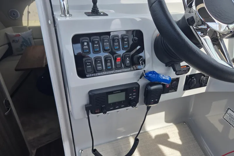 Slide: The Image of 2021 Regal 26 Express boat dashboard with controls and steering wheel. - 4