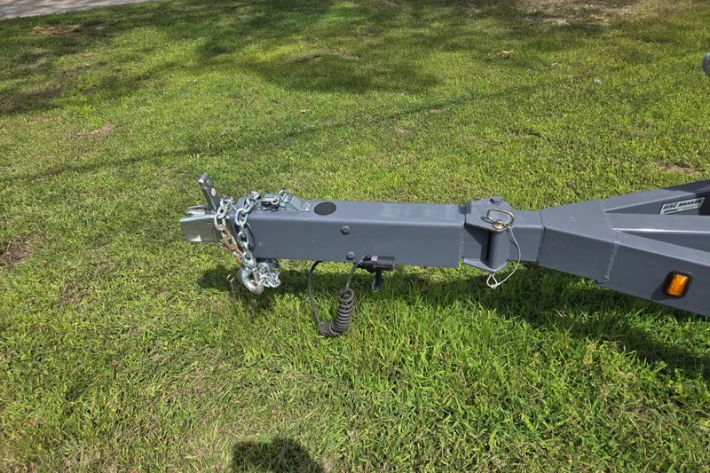 Slide: The Image of Trailer hitch of 2021 Regal 26 Express on grassy area. - 41