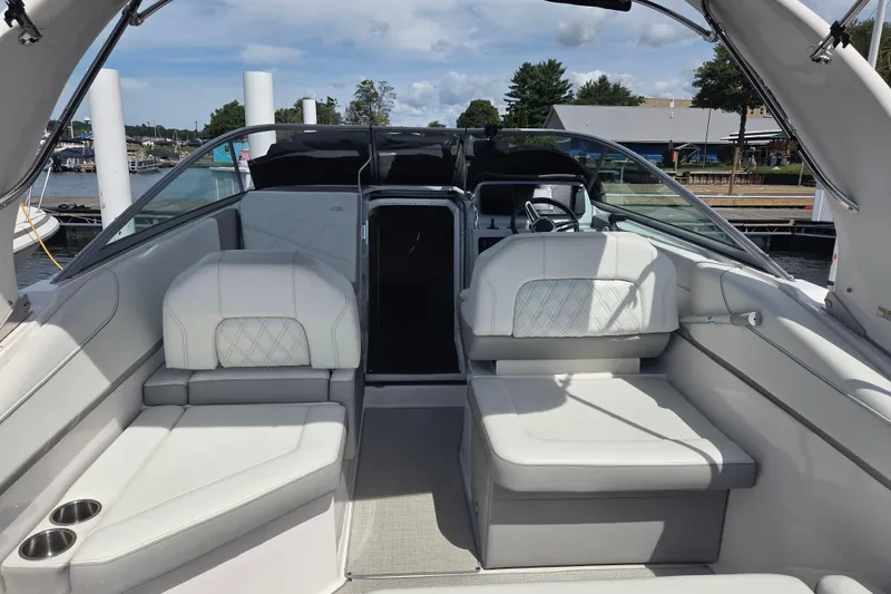 Slide: The Image of 2021 Regal 26 Express boat interior with white seating and steering wheel. - 7