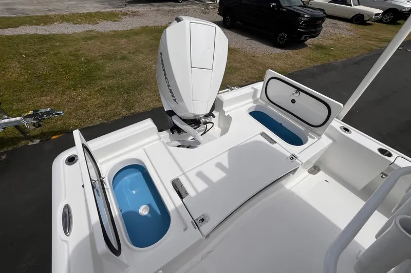 Slide: The Image of 2026 Tidewater 2210 Carolina Bay boat with Mercury engine and open storage compartments. - 16