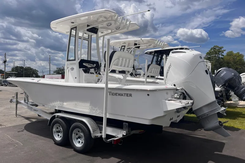 Slide: The Image of 2026 Tidewater 2210 Carolina Bay boat on trailer under cloudy sky. - 2