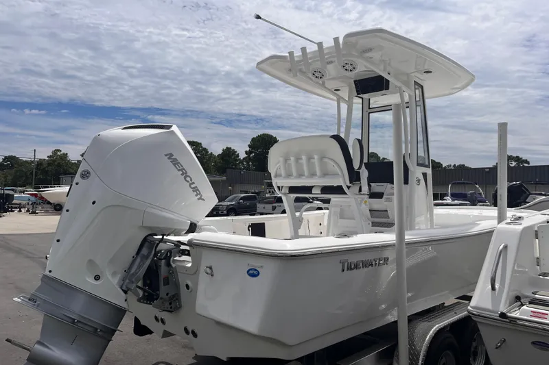 Slide: The Image of 2026 Tidewater 2210 Carolina Bay boat with Mercury engine, parked on a trailer. - 4