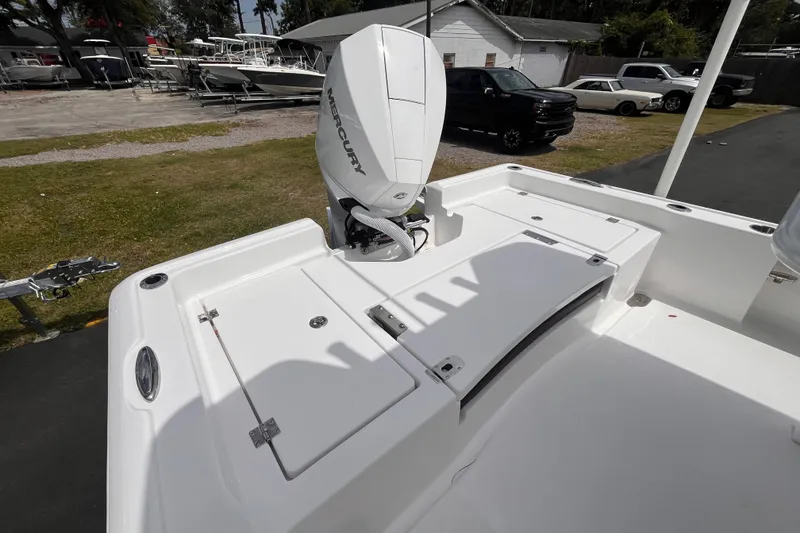 Slide: The Image of 2026 Tidewater 2210 Carolina Bay boat with Mercury engine, docked outdoors. - 5