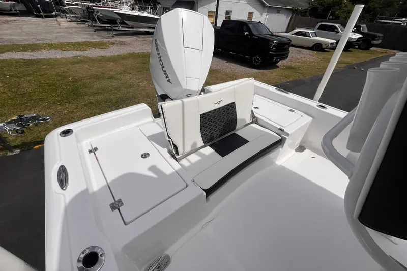 Slide: The Image of 2026 Tidewater 2210 Carolina Bay boat with Mercury engine, featuring sleek seating and storage. - 6