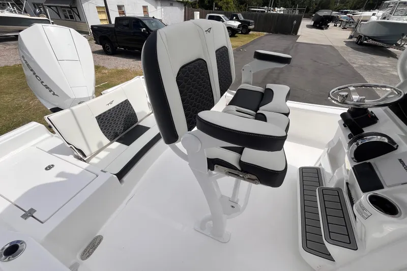 Slide: The Image of 2026 Tidewater 2210 Carolina Bay boat interior with seating and Mercury engine. - 7