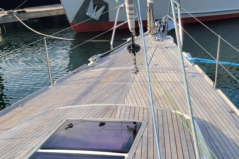 Slide: The Image of Deck view of 2018 Nautor Swan 54 yacht, featuring sleek wooden finish and rigging. - 14