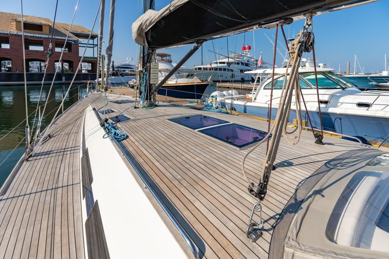Slide: The Image of Sailing yacht Nautor Swan 54, 2018 model, docked at marina with wooden deck. - 17