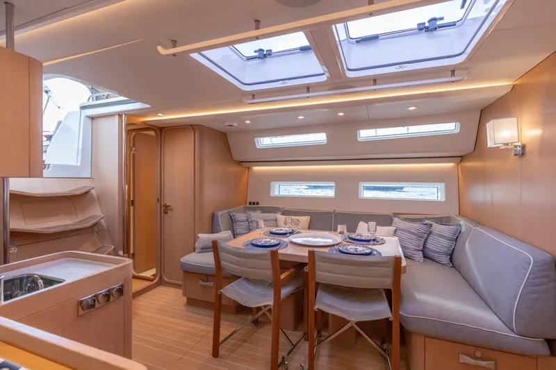 Slide: The Image of Luxurious interior of 2018 Nautor Swan 54 yacht with elegant dining area and skylights. - 19