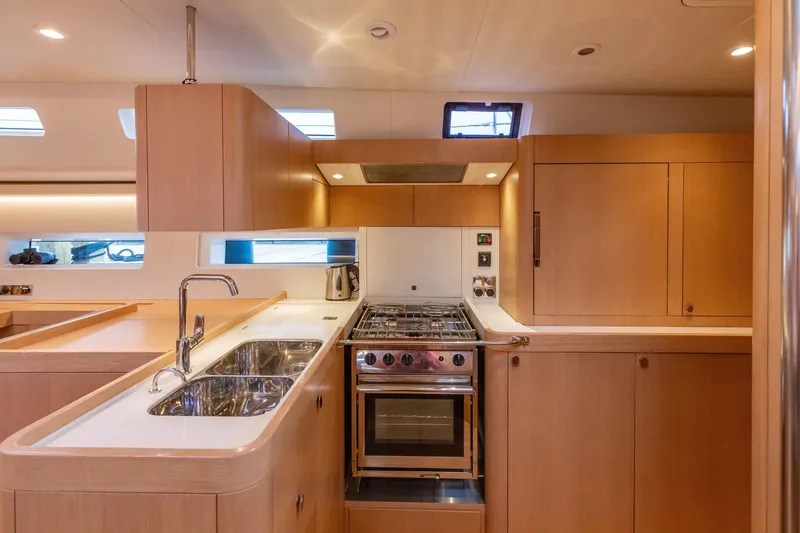 Slide: The Image of Modern kitchen interior of 2018 Nautor Swan 54 yacht with wooden cabinetry and stainless steel appliances. - 22