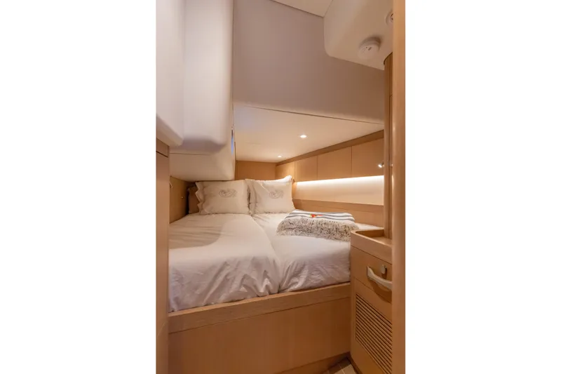 Slide: The Image of Luxurious cabin interior of 2018 Nautor Swan 54 yacht, featuring cozy bedding and elegant wood finishes. - 27