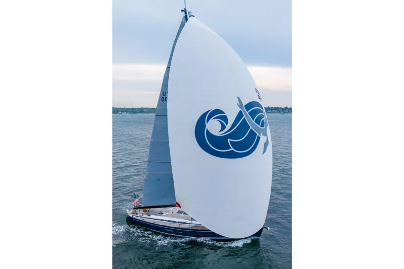 Slide: The Image of 2018 Nautor Swan 54 sailboat with large spinnaker on open water. - 6