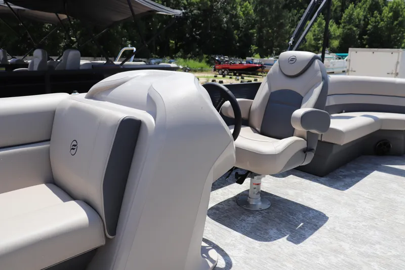 Slide: The Image of 2025 Flagship Freedom 22 CU Tritoon interior with plush seating and steering console. - 4