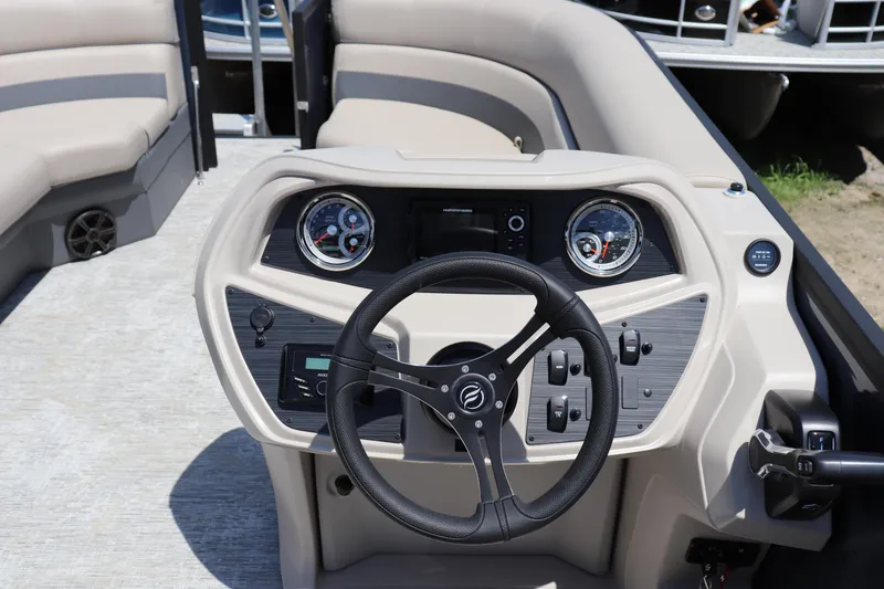 Slide: The Image of 2025 Flagship Freedom 22 CU Tritoon dashboard with steering wheel and control panel. - 5