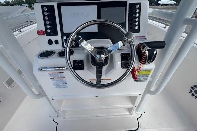 Slide: The Image of 2022 Robalo R222 Explorer boat dashboard with steering wheel and controls. - 13