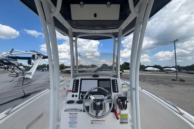 Slide: The Image of 2022 Robalo R222 Explorer boat dashboard with steering wheel and navigation screens. - 18