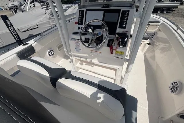Slide: The Image of 2022 Robalo R222 Explorer boat interior with steering console and seating. - 19
