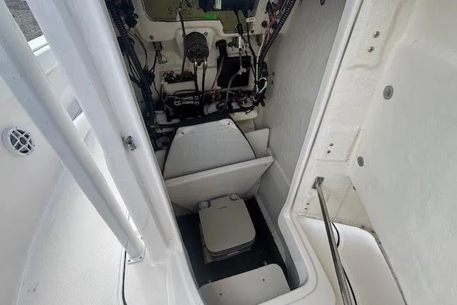 Slide: The Image of 2022 Robalo R222 Explorer boat interior with storage and wiring components. - 21