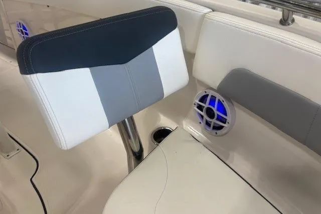 Slide: The Image of 2022 Robalo R222 Explorer boat interior with cushioned seating and blue LED speaker. - 23