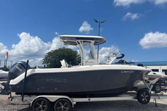 Slide: The Image of 2022 Robalo R222 Explorer boat on trailer under blue sky. - 25