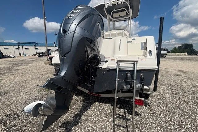 Slide: The Image of 2022 Robalo R222 Explorer boat with Yamaha 150 engine, ladder, and clear sky background. - 27