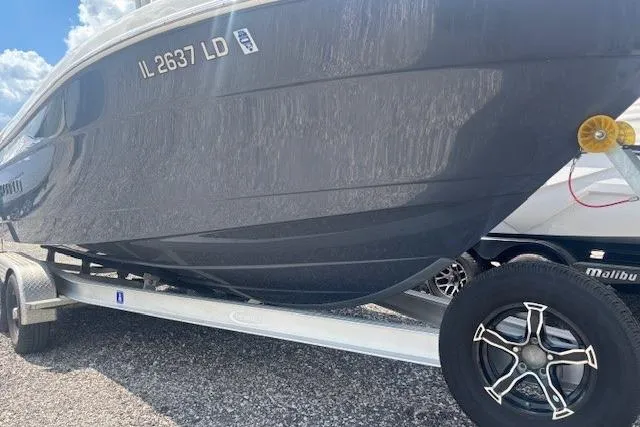 Slide: The Image of 2022 Robalo R222 Explorer boat on trailer, side view, with registration number visible. - 29