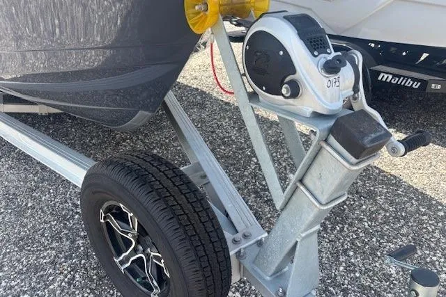 Slide: The Image of 2022 Robalo R222 Explorer boat trailer with winch and wheel on gravel. - 30