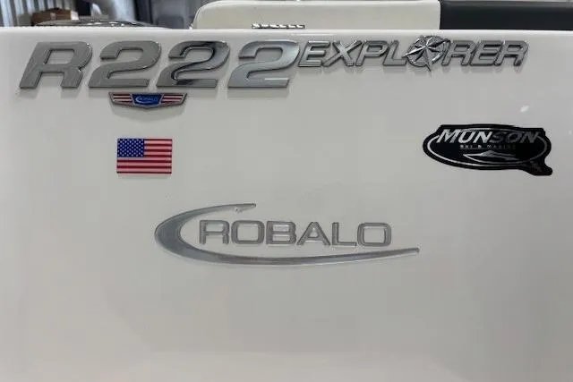 Slide: The Image of 2022 Robalo R222 Explorer boat branding with American flag and Munson logo. - 31