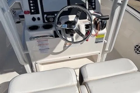 Slide: The Image of 2022 Robalo R222 Explorer boat dashboard with steering wheel and controls. - 37