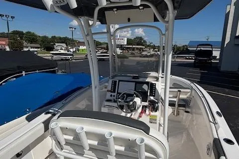 Slide: The Image of 2022 Robalo R222 Explorer boat interior with steering console and rod holders. - 39